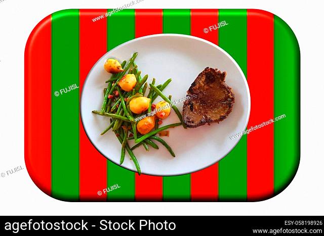 Fried beef liver with vegetables on a white plate on a green-red surface