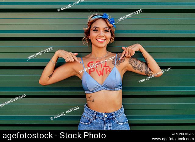 Happy woman with girl power text on her chest
