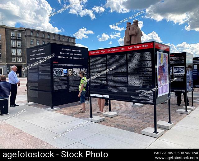 05 July 2022, Latvia, Riga: Visitors look at the information boards of the exhibition ""Endstation Riga"" on Schützenplatz