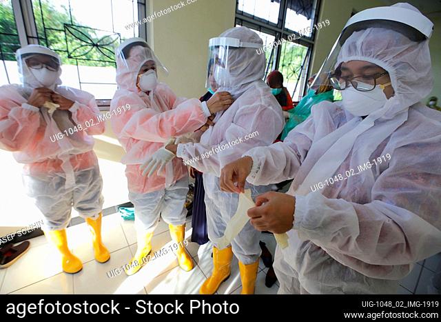 Medical personnel wearing protective suits, during Rapid Test of Covid-19 with Drive Thru system to users of vehicles in Bandung, West Java, Indonesia, April 7