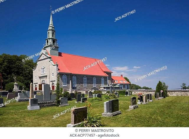Cemetery and Saint-Jean church (1734) in summer, Saint-Jean, Ile d'Orleans, Quebec, Canada