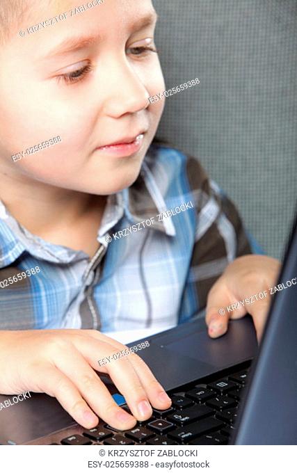 computer addiction boy child with laptop notebook black background