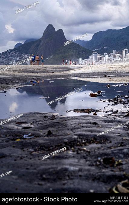 Big Puddle of water after rain reflecting Two Brothers Mountain (Dois Irmaos) at the beach of Ipanema/Leblon in Rio de Janeiro, Brazil. Leica M10