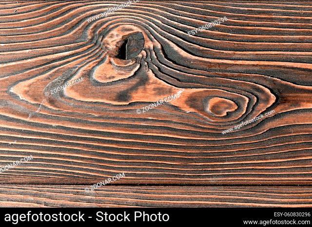 close-up texture larch wood. dark brown countertop or background