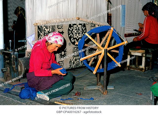 China: Uighur carpet weavers, carpet factory, Khotan, Xinjiang