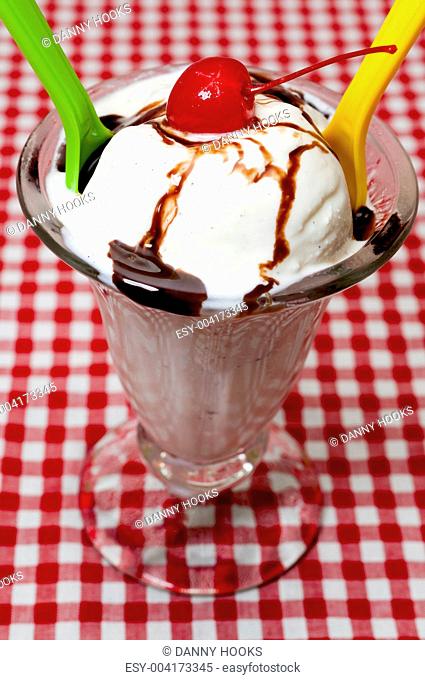 Vanilla Ice Cream and Spoons with Cherry and Chocolate Topping