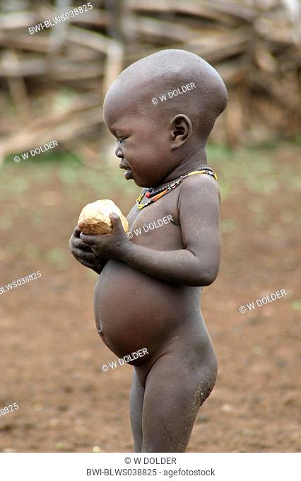 Toposa child with stone in his hands, Sudan
