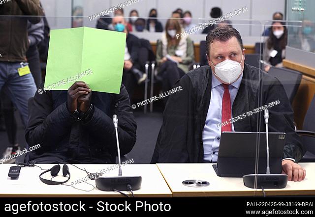 25 April 2022, Lower Saxony, Celle: The Gambian defendant (l) sits next to his lawyer Marco Neumann (r) in the courtroom