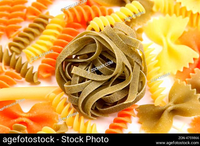 Green tagliatelle paglia e fieno on the backgroun of different pastas