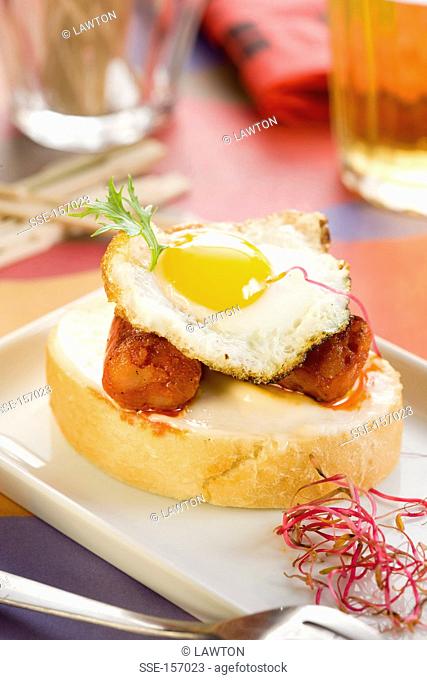 Chistorra and fried quail's egg open sandwich