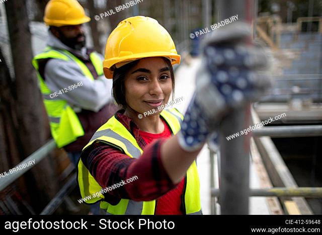 Portrait confident female construction worker at construction site
