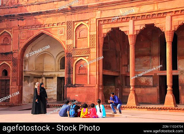 Visitors taking pictures in the courtayrd of Jahangiri Mahal in Agra Fort, Uttar Pradesh, India. The fort was built primarily as a military structure