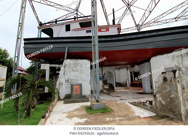 A fishing boat rests on the remaining walls of the home of the Misbah family in Banda Aceh, Indonesia, 30 November 2014. The 20-ton boat was docking at a pier...