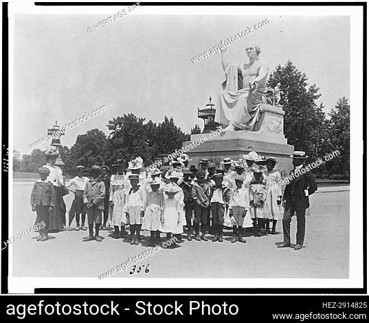 Group of school children in front of statue of George Washington, Washington, D.C., (1899?). Creator: Frances Benjamin Johnston