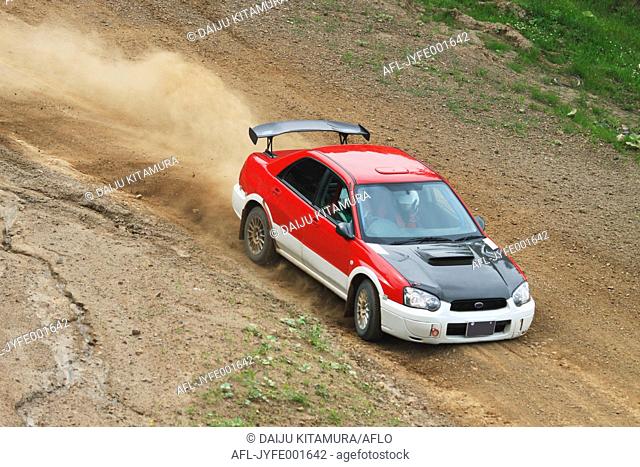 Rally car racing on dirt track