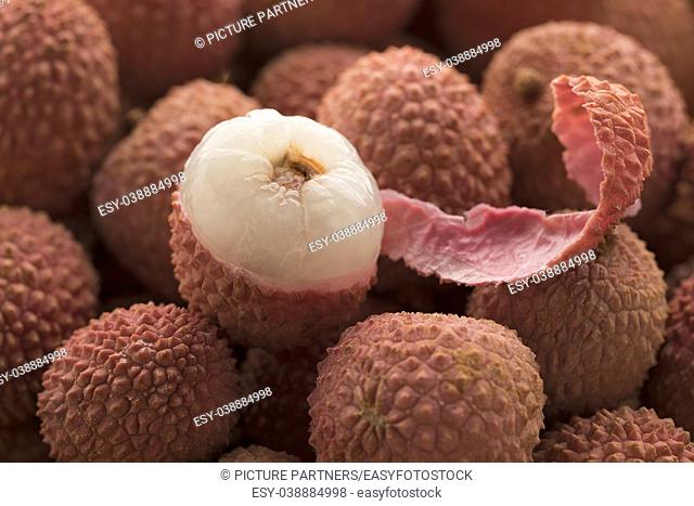 Fresh pink ripe Lychees and a peeled one