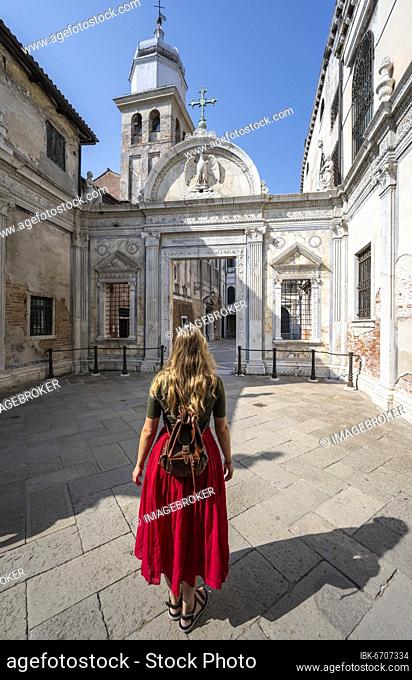 Young woman in front of church San Giovanni Evangelista, Venice, Veneto, Italy, Europe