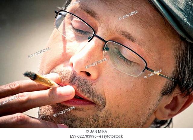 Man smoking hashish joint