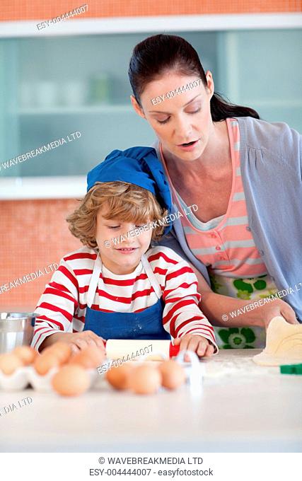 Beautiful mother and her son baking at home
