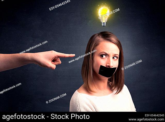 Caucasian hand pointing at female employee with a lightbulb above her head