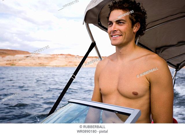 Young man standing on a speed boat