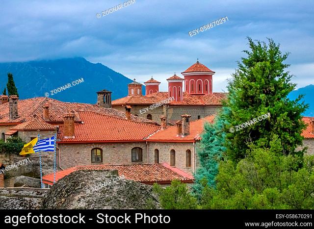 Greece. Summer cloudy day in Meteora. Red roofs and crosses on a greek monastery