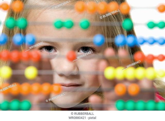 Portrait of a girl using an abacus