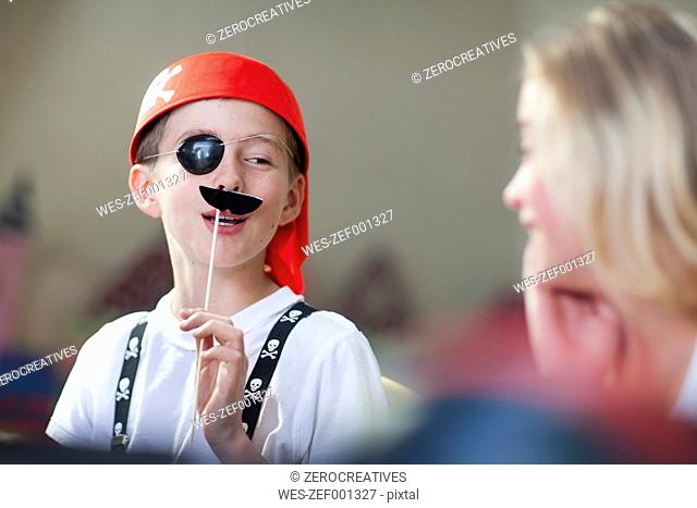 Boy dressed up as pirate having fun on a party