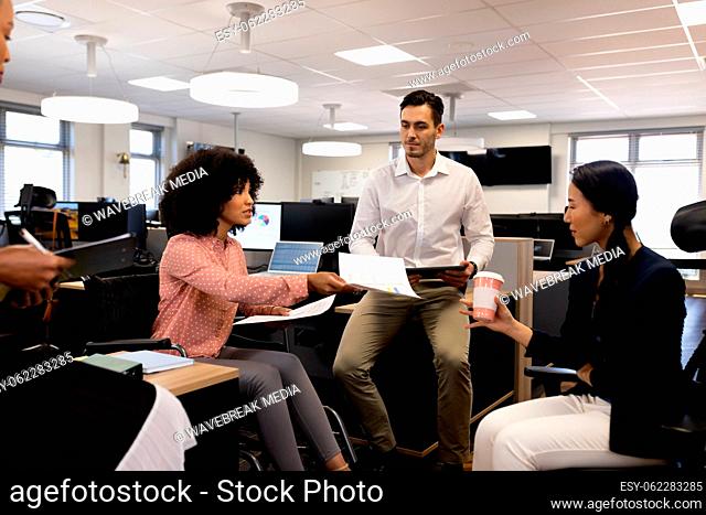 Group of diverse people in office working with documents