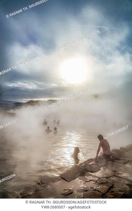 Secret Lagoon. People swimming in a natural hot spring known as The Secret Lagoon, located near the small village of Fludir, a short drive from Reykjavik