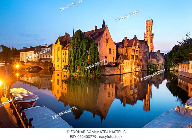 Bruges, Belgium. Image with Rozenhoedkaai in Brugge, Dijver river canal and Belfort, Belfry, tower in twilight