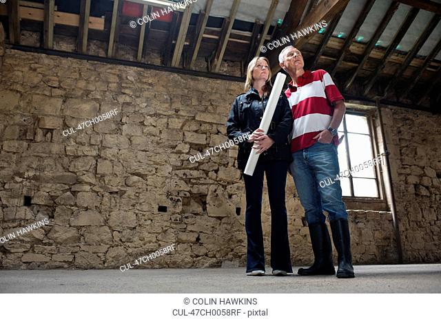 Father and daughter examining building