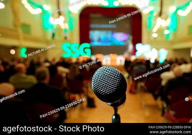 29 June 2023, Saxony, Zwickau: A microphone stands in the hall of the ""Neue Welt"" venue. This is where the Saxon Towns and Municipalities Conference is...