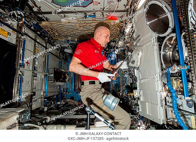 European Space Agency astronaut Luca Parmitano, Expedition 37 flight engineer, works with the Combustion Integrated Rack (CIR) Multi-user Drop Combustion...