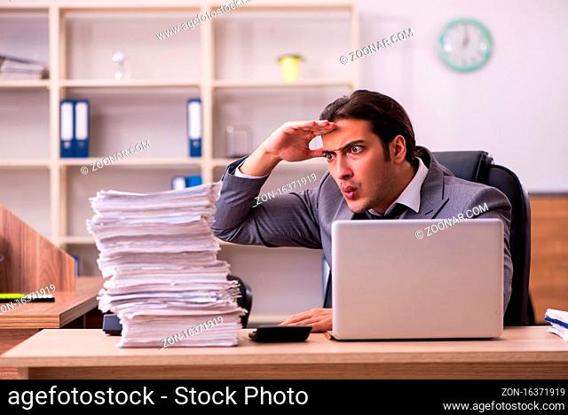 Male employee unhappy with excessive work in the office