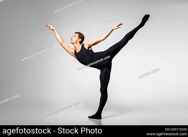 handsome ballet artist. young man in gymnastics clothes. studio shot. copy space