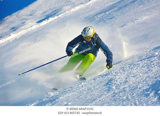 skiing on fresh snow at winter season at beautiful sunny day