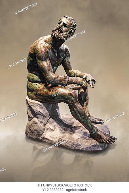 Rare original Greek bronze statue of an Athlete after a boxing match, a 1st cent BC. The athlete, seated on a boulder, is resting after a boxing match