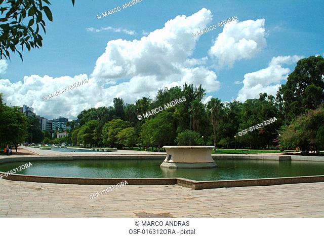 a lake and fountain in porto alegre city park
