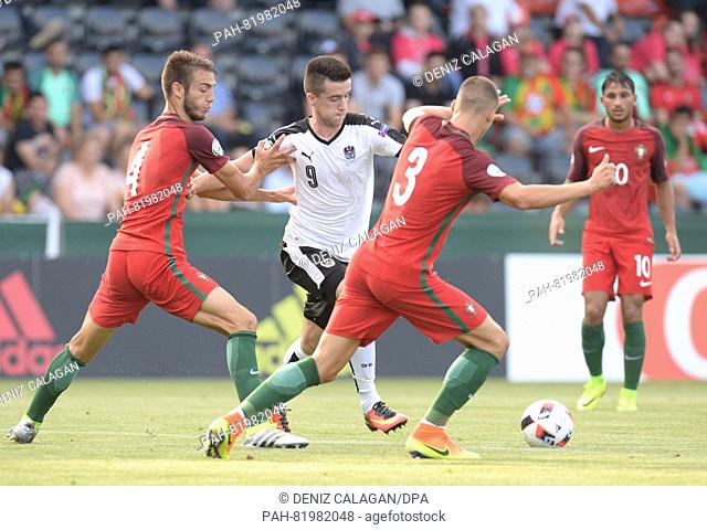 Portugals and Austria players compete for the ball, during the UEFA Under-19 European Championship group A match between Portugal and Austria