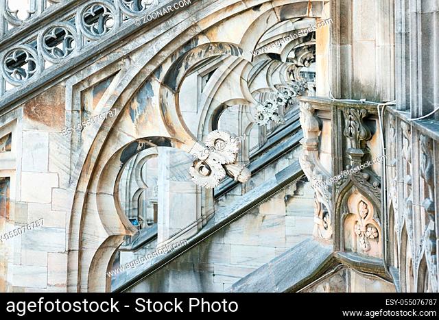 Marble statues - architecture on roof of Duomo gothic cathedral in Milan, Italy