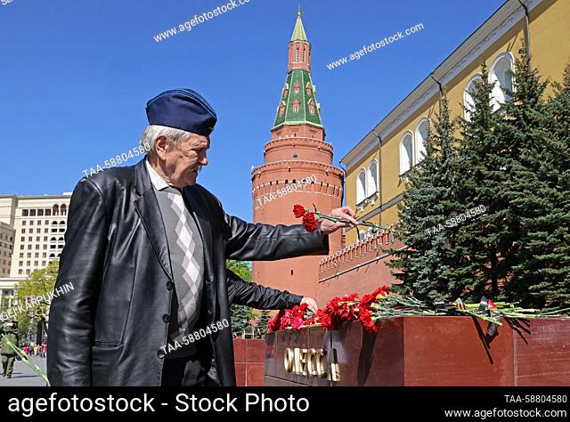 RUSSIA, MOSCOW - MAY 2, 2023: A man lays flowers at the Odessa Hero City Memorial by the Tomb of the Unknown Soldier in Moscow's Alexander Garden by the Kremlin...