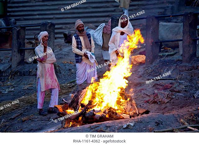 Body burning on funeral pyre at Hindu cremation at Manikarnika crematorium Ghat in Holy City of Varanasi, Benares, India