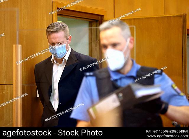 05 November 2020, Hessen, Frankfurt/Main: The main defendant Stephan Ernst (l), who is accused of the murder of the politician Lübcke, enters the courtroom