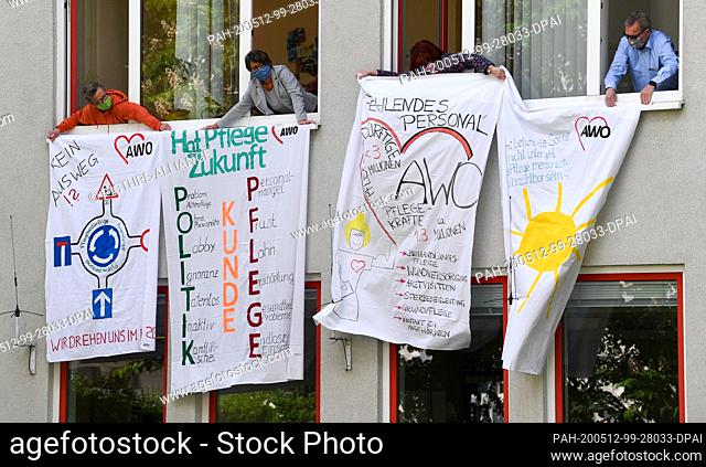 12 May 2020, Saxony, Chemnitz: Employees of the office of the Arbeiterwohlfahrt (AWO) participate with banners in the campaign #denkmalPflege