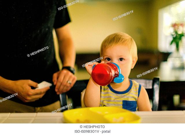 Young boy drinking from sippy cup