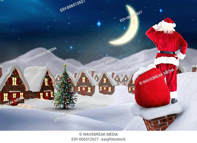 Composite image of santa on cottage roof
