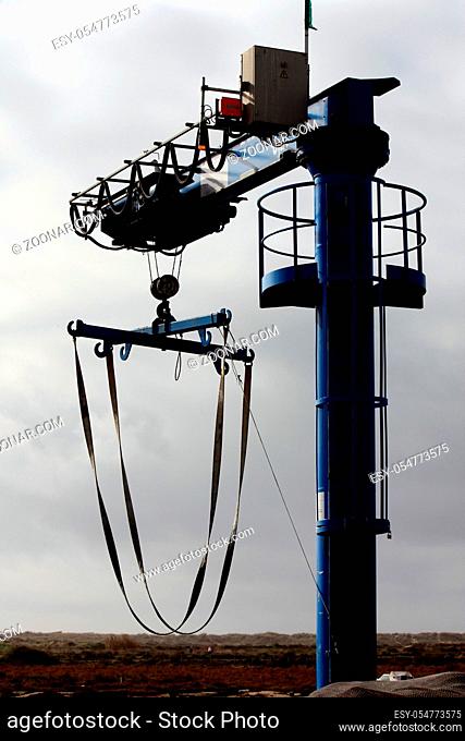 Silhouette view of a blue commercial dock lifter