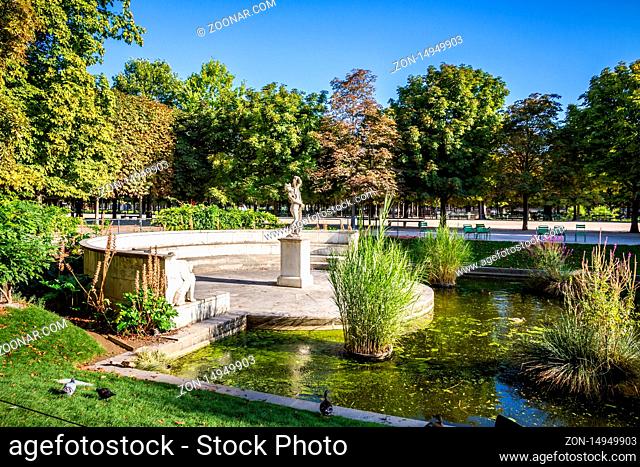 Aisles and pond of the Tuileries Garden in summer Paris, France