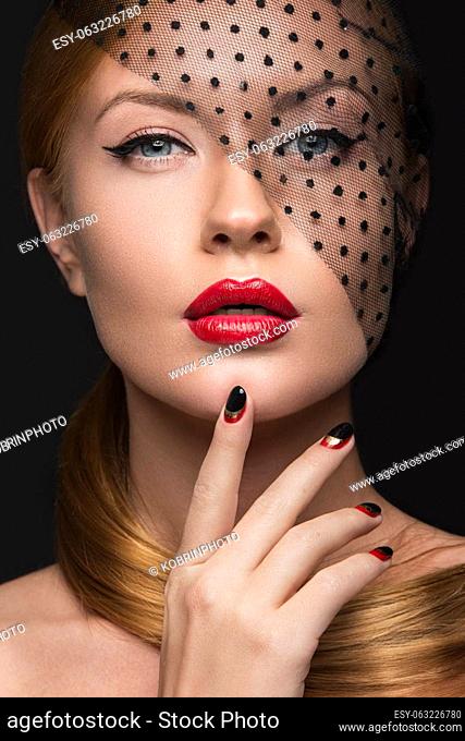 Beautiful girl with a veil, evening makeup, black and red nails. Design manicure. Beauty face. Picture taken in the studio